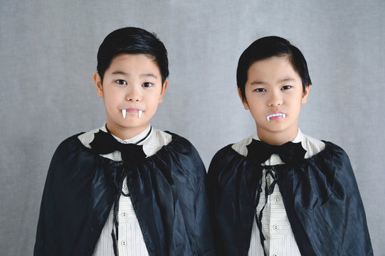 Two little boys in vampire costumes