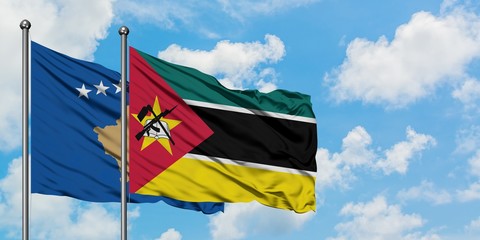 Kosovo and Mozambique flag waving in the wind against white cloudy blue sky together. Diplomacy concept, international relations.