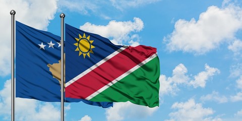 Kosovo and Namibia flag waving in the wind against white cloudy blue sky together. Diplomacy concept, international relations.
