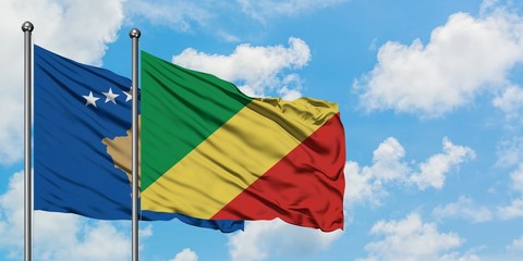 Kosovo and Republic Of The Congo flag waving in the wind against white cloudy blue sky together. Diplomacy concept, international relations.