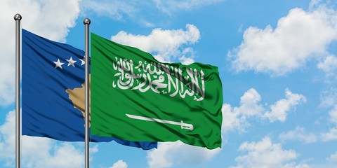 Kosovo and Saudi Arabia flag waving in the wind against white cloudy blue sky together. Diplomacy...