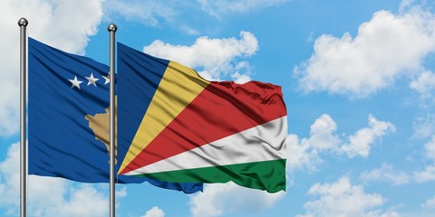 Kosovo and Seychelles flag waving in the wind against white cloudy blue sky together. Diplomacy concept, international relations.