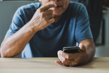 Portrait of an old man using a smartphone