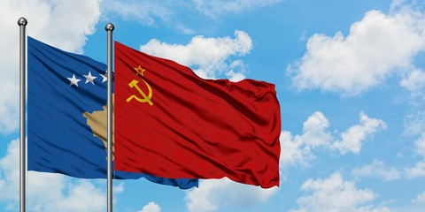 Kosovo and Soviet Union flag waving in the wind against white cloudy blue sky together. Diplomacy concept, international relations.