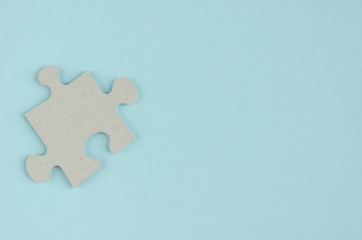 Gray puzzles composition on blue background. Flat lay