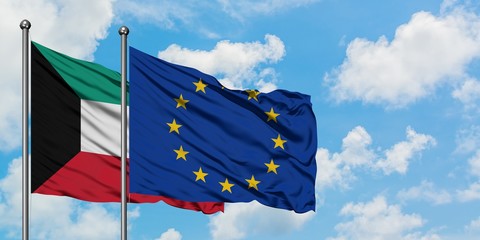 Kuwait and European Union flag waving in the wind against white cloudy blue sky together. Diplomacy concept, international relations.