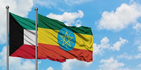 Kuwait and Ethiopia flag waving in the wind against white cloudy blue sky together. Diplomacy concept, international relations.