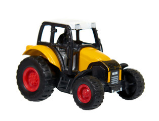 Fototapeta na wymiar Yellow plastic traktor toy. Farming vehicle, harvest equipment.