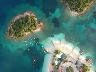 Beautiful Ionian Sea near Ksamil and Sarande with clear turquoise water, piers, aerial view from drone (Ksamil, Albania)
