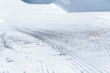 Snow on the prepared ski slopes sunny winter day