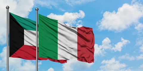Kuwait and Italy flag waving in the wind against white cloudy blue sky together. Diplomacy concept,...