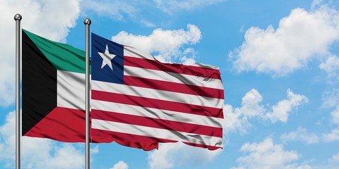 Kuwait and Liberia flag waving in the wind against white cloudy blue sky together. Diplomacy concept, international relations.