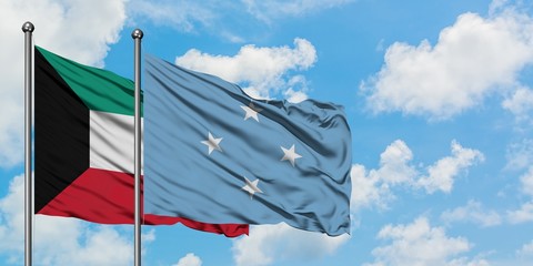 Kuwait and Micronesia flag waving in the wind against white cloudy blue sky together. Diplomacy...