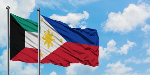 Kuwait and Philippines flag waving in the wind against white cloudy blue sky together. Diplomacy concept, international relations.