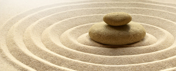 zen garden meditation stone background with stones and lines in sand for relaxation balance and...