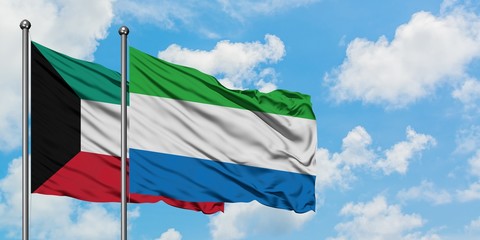 Kuwait and Sierra Leone flag waving in the wind against white cloudy blue sky together. Diplomacy concept, international relations.