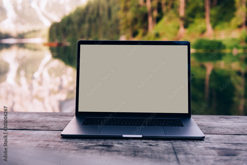 Aufkleber open laptop on wooden table workspace with pure nature on background.computer with copy space screen