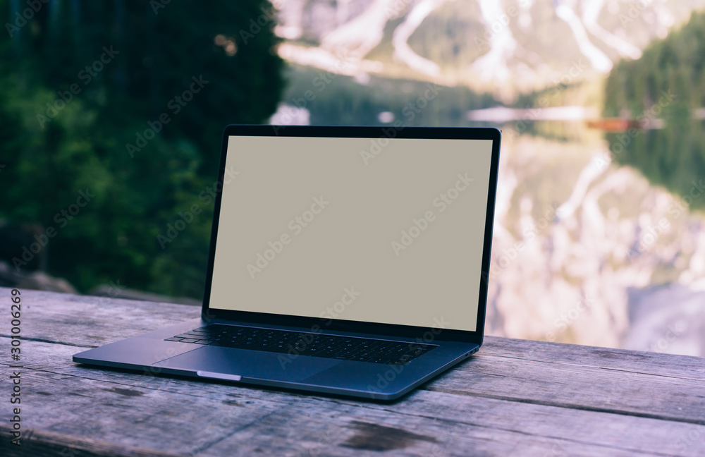 Aufkleber open laptop on wooden table workspace with pure nature on background.computer with copy space screen