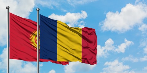 Kyrgyzstan and Chad flag waving in the wind against white cloudy blue sky together. Diplomacy concept, international relations.