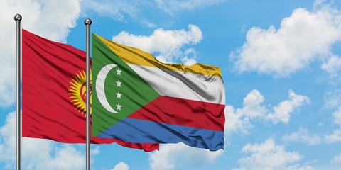 Kyrgyzstan and Comoros flag waving in the wind against white cloudy blue sky together. Diplomacy concept, international relations.