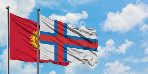 Kyrgyzstan and Faroe Islands flag waving in the wind against white cloudy blue sky together. Diplomacy concept, international relations.