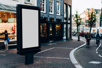 Clear Billboard on city street with blank copy space screen for advertising or promotional poster content, empty mock up Lightbox for information in Amsterdam, blank display outdoors in urban area © BullRun