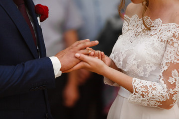 two gold wedding rings. the bride wears the groom wedding ring. newlyweds with  rings on ...