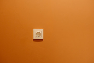 white rosette on orange wall