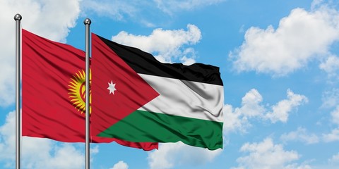 Kyrgyzstan and Jordan flag waving in the wind against white cloudy blue sky together. Diplomacy concept, international relations.