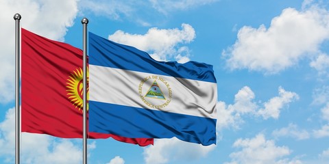 Kyrgyzstan and Nicaragua flag waving in the wind against white cloudy blue sky together. Diplomacy concept, international relations.