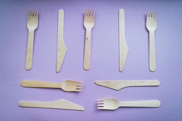 Reusable bamboo forks and knives on pink background. Eco friendly concept. Top view.