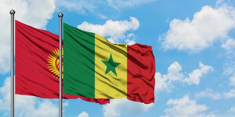 Kyrgyzstan and Senegal flag waving in the wind against white cloudy blue sky together. Diplomacy concept, international relations.