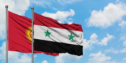 Kyrgyzstan and Syria flag waving in the wind against white cloudy blue sky together. Diplomacy...