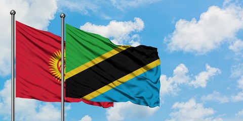Kyrgyzstan and Tanzania flag waving in the wind against white cloudy blue sky together. Diplomacy concept, international relations.