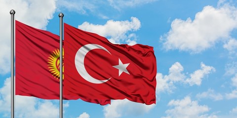 Kyrgyzstan and Turkey flag waving in the wind against white cloudy blue sky together. Diplomacy concept, international relations.