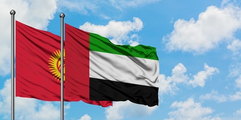 Kyrgyzstan and United Arab Emirates flag waving in the wind against white cloudy blue sky together. Diplomacy concept, international relations.