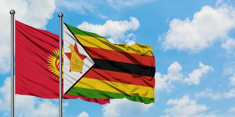 Kyrgyzstan and Zimbabwe flag waving in the wind against white cloudy blue sky together. Diplomacy concept, international relations.