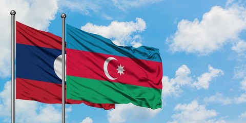 Laos and Azerbaijan flag waving in the wind against white cloudy blue sky together. Diplomacy concept, international relations.