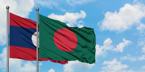 Laos and Bangladesh flag waving in the wind against white cloudy blue sky together. Diplomacy concept, international relations.
