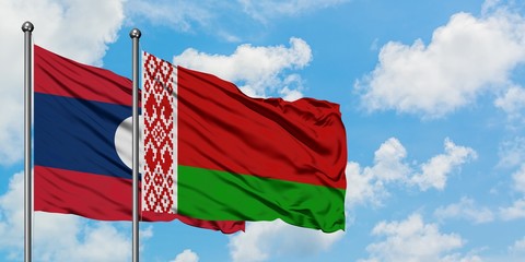 Laos and Belarus flag waving in the wind against white cloudy blue sky together. Diplomacy concept, international relations.