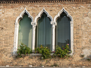 Fototapeta na wymiar Venetian style windows in an old house. Background with eastern windows. Travel photo.