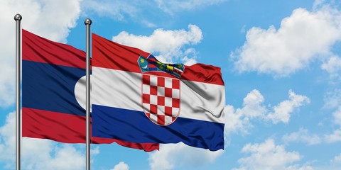 Laos and Croatia flag waving in the wind against white cloudy blue sky together. Diplomacy concept, international relations.