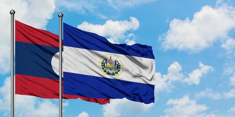Laos and El Salvador flag waving in the wind against white cloudy blue sky together. Diplomacy concept, international relations.