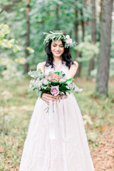 Fototapeta na wymiar Beautiful smiling bride brunette young woman in the white dress with wedding bouquet, close up portrait outdoors. Focus on bouquet