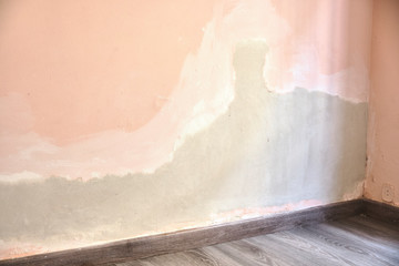 Recently plastered and smoothed out wall. Insurance fix of a pipe water leak. Professional work, unfinished.