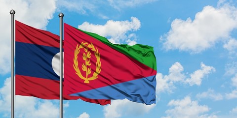 Laos and Eritrea flag waving in the wind against white cloudy blue sky together. Diplomacy concept, international relations.