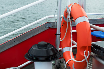 Orange lifebuoy on a boat.