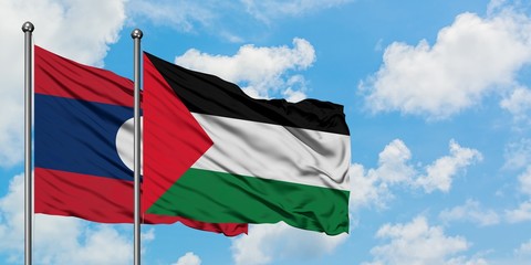 Laos and Palestine flag waving in the wind against white cloudy blue sky together. Diplomacy concept, international relations.