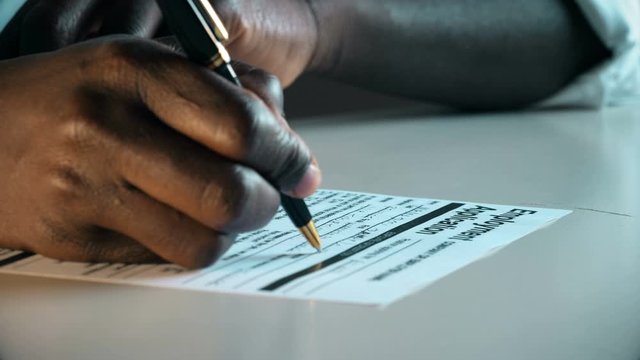 black migrant hand Filling An Employment Application.Job,application,migration