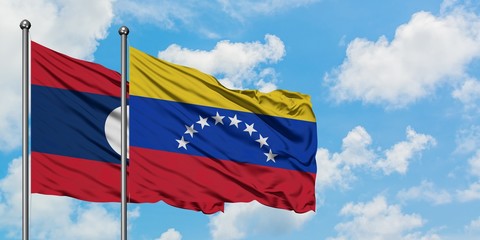 Laos and Venezuela flag waving in the wind against white cloudy blue sky together. Diplomacy concept, international relations.